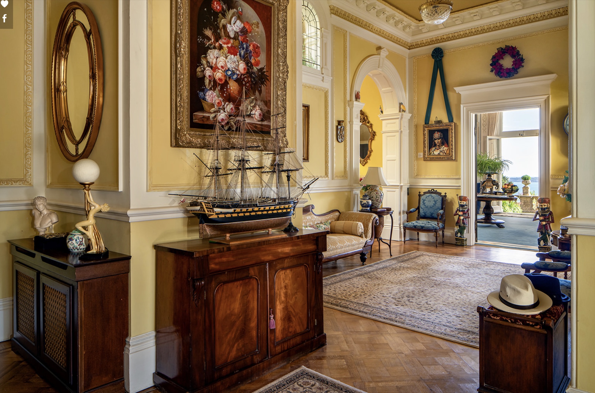 The entrance hall at Wylam House &mdash; model ship, floral canvas, and the sea beyond